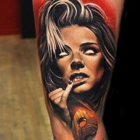 Creepy looking colored arm tattoo of demonic woman face