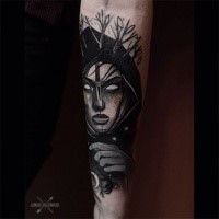 Creepy looking colored arm tattoo of woman face with moon and trees