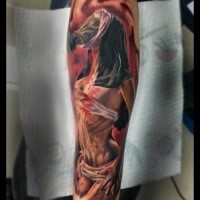 Creepy looking colored forearm tattoo of monster mother in gas mask