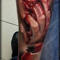 Creepy looking colored forearm tattoo of bloody woman's mouth