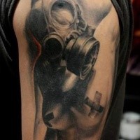 Creepy looking colored shoulder tattoo of man with gas mask