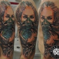 Creepy looking colored shoulder tattoo of monster woman face with skull