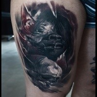 Creepy looking colored thigh tattoo of demonic woman with human skull