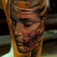 Creepy looking leg tattoo of bloody woman face