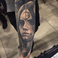 Creepy looking portrait style black ink leg tattoo of demonic woman portrait with symbol