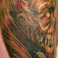 Creepy painted and colored big monster face tattoo on arm