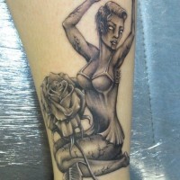 Creepy painted black and white seductive zombie woman tattoo with flower on thigh