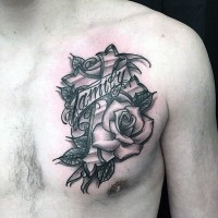 Cross with rose and lettering family on banner tattoo on chest