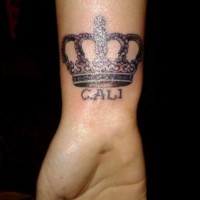 Crown and inscription tattoo for young women