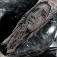 Crying Virgin Mary with chain cross in praying hands religious realistic forearm tattoo