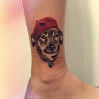 Cubism dog in a red beret ankle tattoo