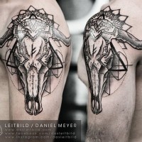 Cult style black and white animal skull with ornaments tattoo on shoulder