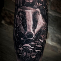 Cute badger in flowers and mushrooms tattoo on foream