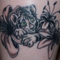 Cute cartoon like colored baby tiger tattoo combined with jungle flowers
