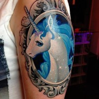 Cute cartoon unicorn in grotesque old frame colored shoulder tattoo with tiny sparkles