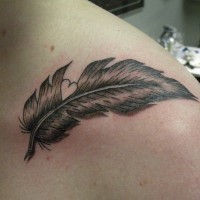 Cute gray-ink feather with white heart tattoo on shoulder