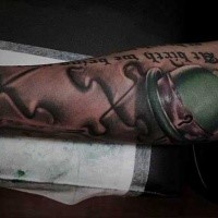 Cute green colored small Leprechaun hat tattoo on forearm combined with puzzle pieces