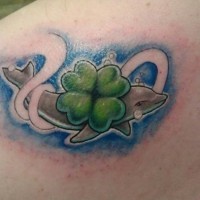 Cute little colored dolphin with clover tattoo on shoulder