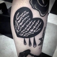 Cute looking black ink leg tattoo of heart with skeleton hands