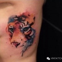 Cute looking colored side tattoo of tiger head with lettering