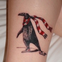 Cute looking colored tattoo of penguin with scarf