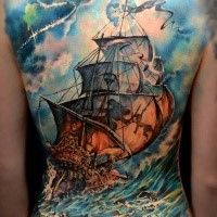 Cute looking colored whole back tattoo of large sailing ship with bi waves