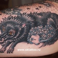 Cute looking old school style wolf with sheep tattoo on leg