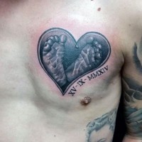 Cute memorial style black ink heart with baby feet tattoo on chest