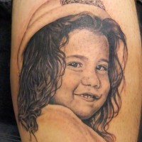 Cute realistic black and white little girl portrait tattoo on arm