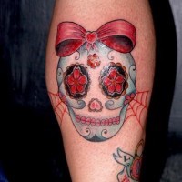Cute sugar skull with a red bow tattoo
