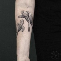 Cute swimming volume turtles tattoo on man's forearm in geometrical style dotted work