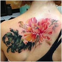 Cute watercolor painted big flower tattoo on upper back