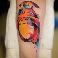 Cute watercolor painted colorful cartoon monster forearm tattoo
