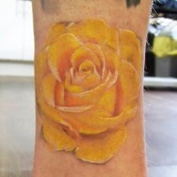 Cute yellow rose tattoo on leg
