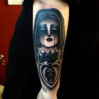 Dark black and white arm tattoo of woman with hood and burning heat stylized with skull