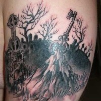 Dark black ink cemetery tattoo on shoulder with mystic key