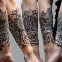 Dark black ink engraving style forearm tattoo of various flowers