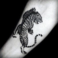 Dark black ink forearm tattoo of tiger
