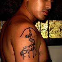 Dark black ink Sagittarius tattoo on shoulder in tribal style