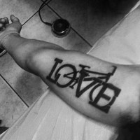 Dark black ink thick lettering love stylized with cycle original tattoo on arm