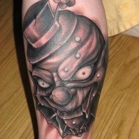 Dark clown in a hat with a flower tattoo on leg