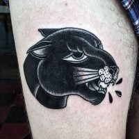 Dark colored black panther head thigh tattoo in old school style