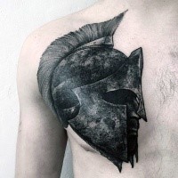 Dark colored Spartan warrior's head in helmet detailed chest tattoo