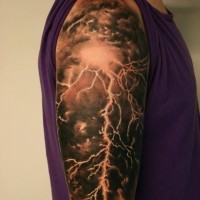 Delightful colorful lightning tattoo on shoulder