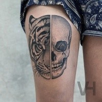 Designed by Valentin Hirsch don style thigh tattoo of split human skull and tigers head