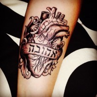 Tatuaje en el brazo,
 cráneo humano con escrito hebreo