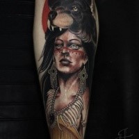 Detailed and colored forearm tattoo of Indian woman with bear helmet