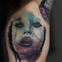 Detailed biceps tattoo of creepy woman face