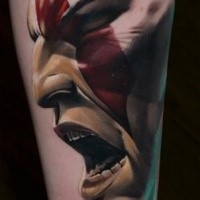 Detailed colored forearm tattoo of screaming barbarian