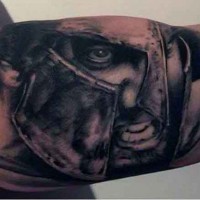 Detailed looking black and white biceps tattoo of Spartan warrior portrait